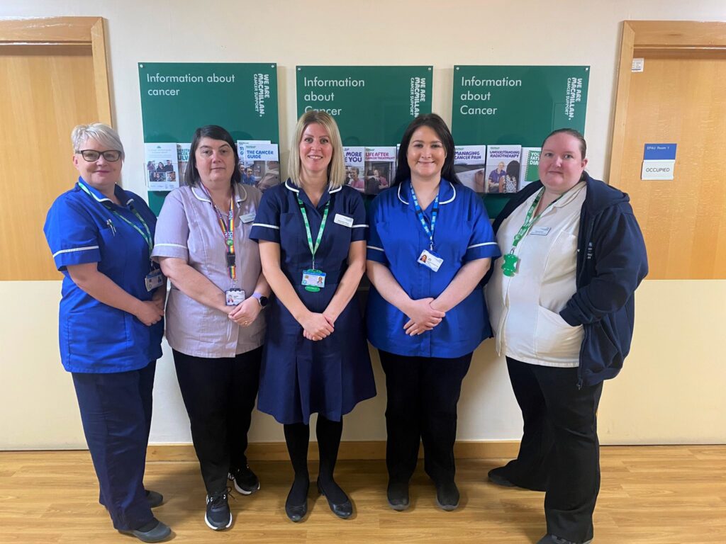 A team picture of the Cancer Nurse Specialists in Gynaecology. Five, white, female colleagues are standing in their uniform in a line